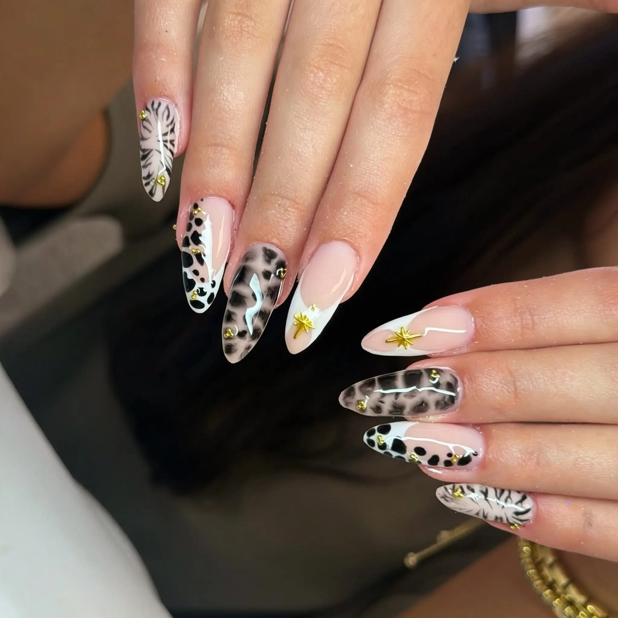 Animal print nail art with gold stars